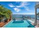 Luxury pool with a hot tub and lounge chairs overlooking the bay at 110 10Th S St, Bradenton Beach, FL 34217
