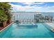 Gorgeous backyard retreat showcasing a sparkling pool, spa, and scenic waterfront views for ultimate relaxation and enjoyment at 110 10Th S St, Bradenton Beach, FL 34217