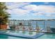 Inviting outdoor space featuring a relaxing pool and a charming dockside area with lounge chairs by the water at 110 10Th S St, Bradenton Beach, FL 34217
