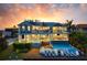 A backyard featuring a pool, a lounge area and a spiral staircase leading to the rooftop deck at 110 10Th S St, Bradenton Beach, FL 34217