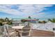 Rooftop deck features outdoor seating and partial views of the ocean at 110 10Th S St, Bradenton Beach, FL 34217