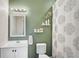 Bathroom with sleek vanity, decorative shower curtain, and neutral green accent wall at 12124 60Th E St, Parrish, FL 34219