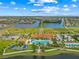 Aerial view of community clubhouse with a large pool, tennis courts and walking paths at 13320 Coluccio St, Venice, FL 34293