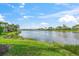 Picturesque lakefront view showcasing the serene water and lush landscaping at 13320 Coluccio St, Venice, FL 34293