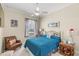 Bedroom with a ceiling fan, picture window, furniture, and blue patterned bedding at 13320 Coluccio St, Venice, FL 34293