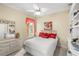 Bedroom with a double bed, dresser, nightstand, and large picture window at 13320 Coluccio St, Venice, FL 34293