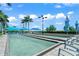 Enjoy community bocce ball courts with shaded seating areas under a bright blue, partly cloudy sky at 13320 Coluccio St, Venice, FL 34293