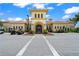 Exterior view of a clubhouse with lush landscaping, parking and golf carts at 13320 Coluccio St, Venice, FL 34293