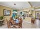 Dining area with elegant chandelier lighting and a view into the kitchen at 13320 Coluccio St, Venice, FL 34293