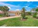 Beautiful single-story home with a well-manicured lawn and mature palm trees at 13320 Coluccio St, Venice, FL 34293