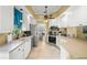 Well-lit kitchen with stainless appliances and a view to the outdoor lanai at 13320 Coluccio St, Venice, FL 34293