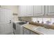 Bright laundry room featuring a utility sink, and washer and dryer at 13320 Coluccio St, Venice, FL 34293