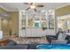 Living room featuring a large sofa, built-in shelving, and view into other rooms of the home at 13320 Coluccio St, Venice, FL 34293