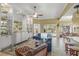 Open living space featuring built-in shelving, tile floors, and sliding glass doors leading to the outdoor space at 13320 Coluccio St, Venice, FL 34293