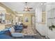 Bright living room featuring a large sofa, shelving, and view into other rooms of the home at 13320 Coluccio St, Venice, FL 34293
