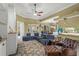 Open concept living room with neutral paint, ceiling fan and tile flooring at 13320 Coluccio St, Venice, FL 34293