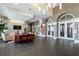 Spacious lobby featuring a lounge area, elegant lighting, and stone accent wall at 13320 Coluccio St, Venice, FL 34293