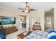 Bright primary bedroom featuring ceiling fan with views into the living room at 13320 Coluccio St, Venice, FL 34293