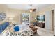 Bright primary bedroom featuring ceiling fan and sliding glass doors to the outdoor patio at 13320 Coluccio St, Venice, FL 34293