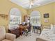 Office features two windows, a ceiling fan, computer desk, chair, printer and day bed at 13320 Coluccio St, Venice, FL 34293