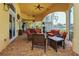 Covered outdoor patio with comfortable seating, offering a relaxing space to enjoy the surrounding views at 13320 Coluccio St, Venice, FL 34293