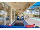 Relaxing covered patio with ceiling fans and comfortable seating overlooking the pool at 13320 Coluccio St, Venice, FL 34293