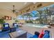 Beautiful screened-in pool area with comfortable seating overlooking the water at 13320 Coluccio St, Venice, FL 34293