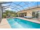 Expansive screened-in pool with outdoor seating, a hammock, and a grill at 13320 Coluccio St, Venice, FL 34293