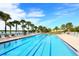 Inviting outdoor swimming pool with lane dividers and poolside lounge chairs, perfect for recreation and relaxation at 13320 Coluccio St, Venice, FL 34293