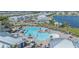 Aerial view of a community pool, lake, and residences with well-kept landscaping at 14061 Heritage Landing Blvd # 412, Punta Gorda, FL 33955
