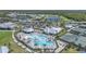 Aerial view of a community pool, clubhouse, tennis courts, and community amenities at 14061 Heritage Landing Blvd # 412, Punta Gorda, FL 33955
