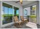 Outdoor lanai featuring two wooden rocking chairs overlooking backyard at 14061 Heritage Landing Blvd # 412, Punta Gorda, FL 33955