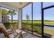 Outdoor lanai with chairs featuring screened-in enclosure overlooking scenic backyard at 14061 Heritage Landing Blvd # 412, Punta Gorda, FL 33955