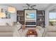 Inviting living room with a modern fireplace, shelving, and comfortable seating area at 14061 Heritage Landing Blvd # 412, Punta Gorda, FL 33955
