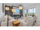 Beautiful living room featuring stylish furniture, a modern fireplace, and a view of the lush green landscape at 14061 Heritage Landing Blvd # 412, Punta Gorda, FL 33955