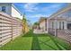 Well-maintained backyard with manicured lawn, privacy fence, and seamless flow to screened in lanai at 1511 N Lake Shore Dr, Sarasota, FL 34231