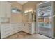 Bathroom featuring white cabinetry, and access to the pool at 1511 N Lake Shore Dr, Sarasota, FL 34231