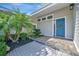 Close-up of a modern front entrance with a vibrant blue door and decorative wreath at 1511 N Lake Shore Dr, Sarasota, FL 34231
