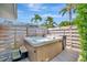 Relaxing hot tub nestled on a wood deck, surrounded by palm trees and lush greenery at 1511 N Lake Shore Dr, Sarasota, FL 34231