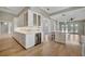 Open kitchen with breakfast bar, wine cooler, and white cabinets at 1511 N Lake Shore Dr, Sarasota, FL 34231