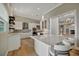 Modern kitchen with stainless steel appliances, white cabinetry, and a center island with barstool seating at 1511 N Lake Shore Dr, Sarasota, FL 34231