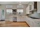 Bright kitchen with stainless steel appliances, subway tile backsplash, and wood flooring at 1511 N Lake Shore Dr, Sarasota, FL 34231