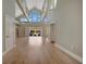 Bright and spacious living room with vaulted ceilings, hardwood floors, and large windows at 1511 N Lake Shore Dr, Sarasota, FL 34231