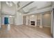 Elegant living room with a fireplace, built-in shelving, and hardwood floors bathed in natural light at 1511 N Lake Shore Dr, Sarasota, FL 34231