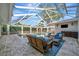 Outdoor pool area with wicker furniture and screened enclosure at 1511 N Lake Shore Dr, Sarasota, FL 34231