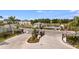 Gated community entrance with a view of the pool and amenity center at 15116 Cuzcorro Ct, Nokomis, FL 34275