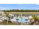 Aerial view of a stunning pool with cabanas and a lake view at 15116 Cuzcorro Ct, Nokomis, FL 34275