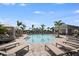 Community pool with lounge seating, cabana, and covered area; perfect for relaxation at 15116 Cuzcorro Ct, Nokomis, FL 34275