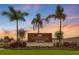 VinTerra Townhomes sign amidst a colorful sunset and palm trees, beautiful community entrance at 15116 Cuzcorro Ct, Nokomis, FL 34275