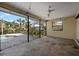 Enclosed patio with tile flooring overlooks pool with mature landscaping at 1855 Buccaneer Ct, Sarasota, FL 34231